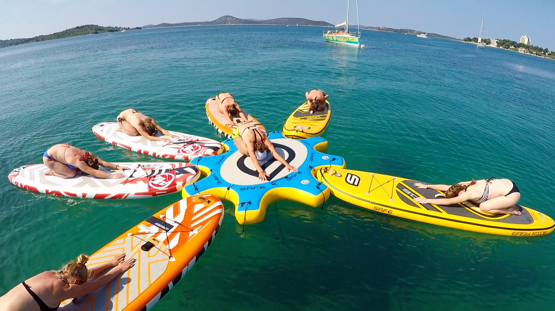 A group of girls exercising on SUPs - in water!